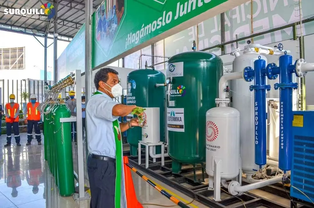 Technician inspecting a Peru medical oxygen station